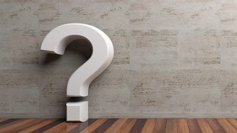 question-mark-on-wooden-floor-and-marble-wall-back-P3N4LEY-scaled